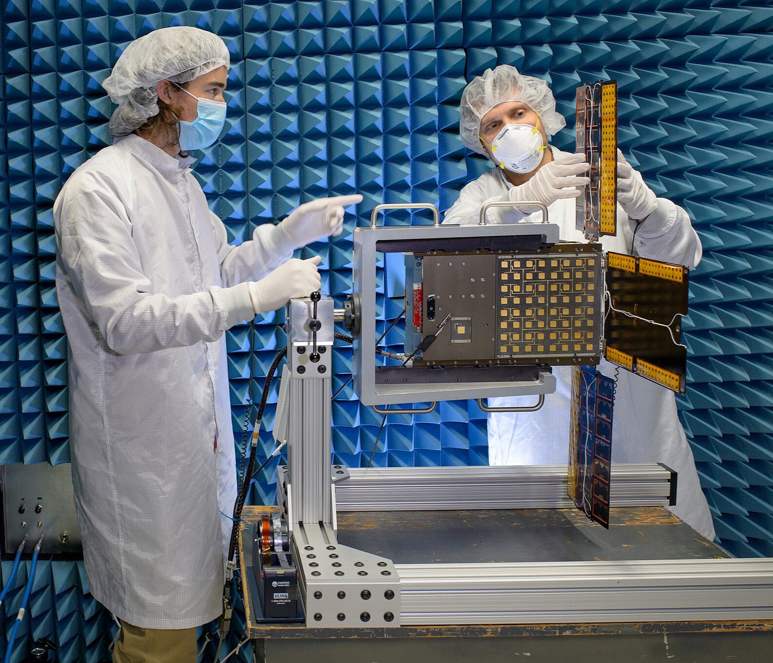 Engineers EMC-testing a device in an anechoic chamber